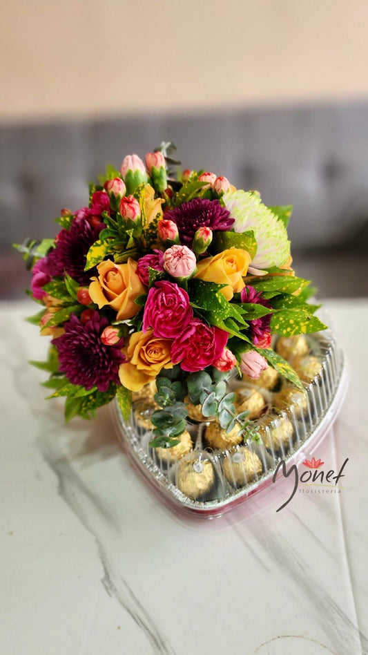 corazón con chocolate y flores primaverales